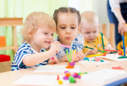 happy kids doing arts and crafts in day care centre happy kids modeling or playing in kindergarten with interest